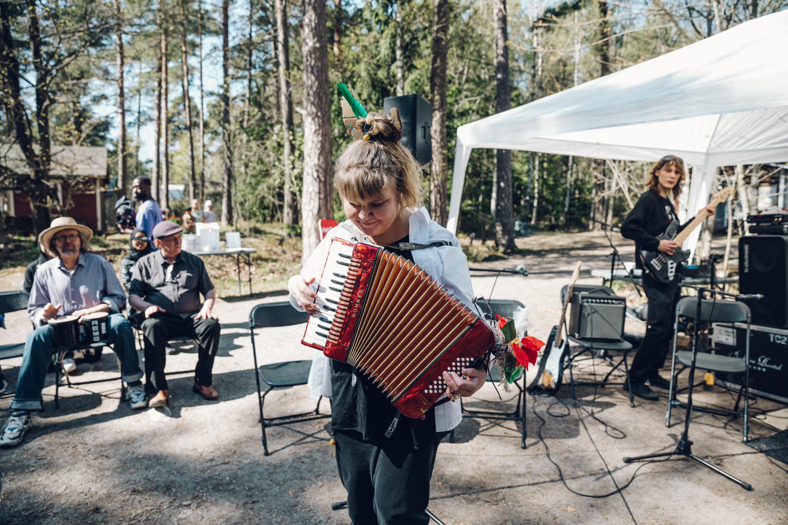 A person playing an accordion in Chicago Boys public rehearsal in Stansvik village