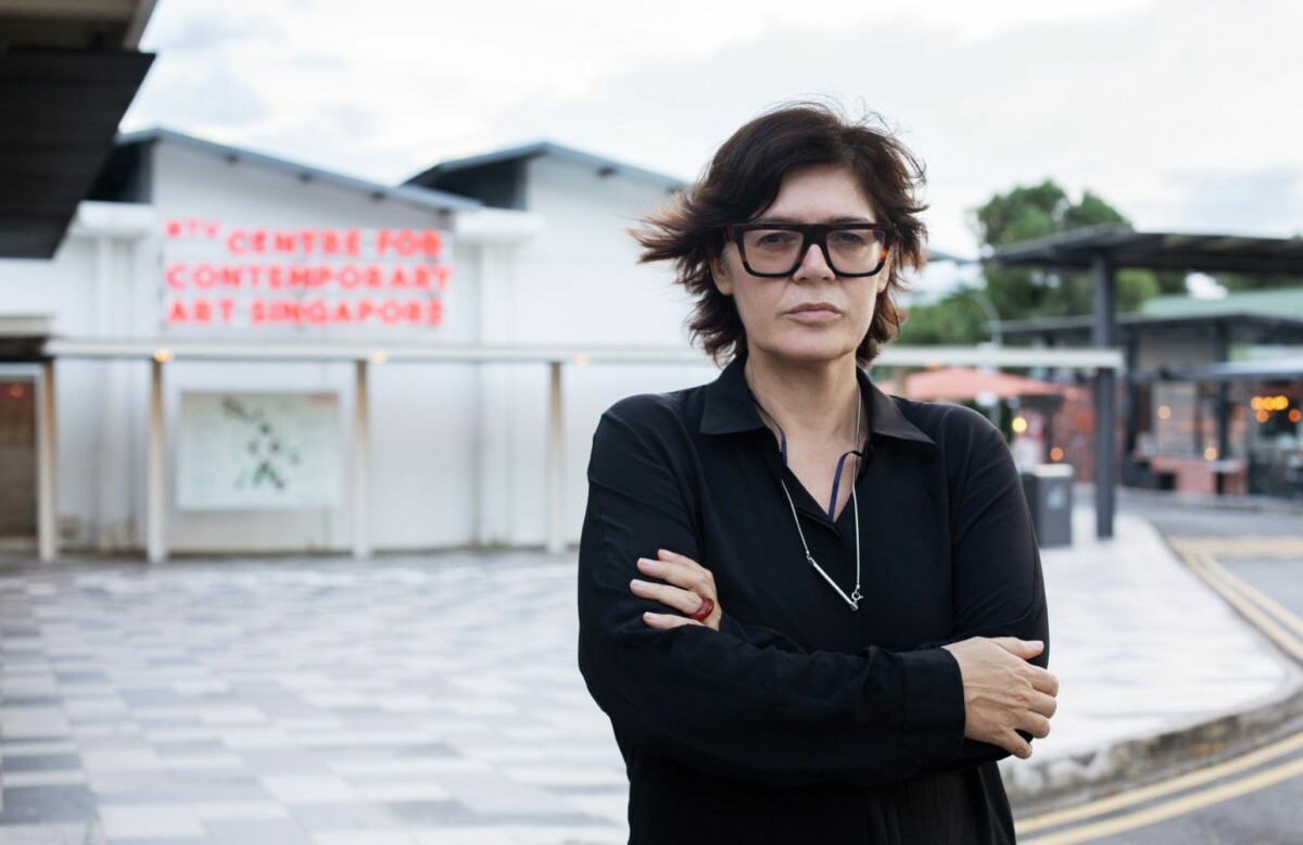 Ute Meta Bauer, a woman standing outside wearing glasses and hands crossed