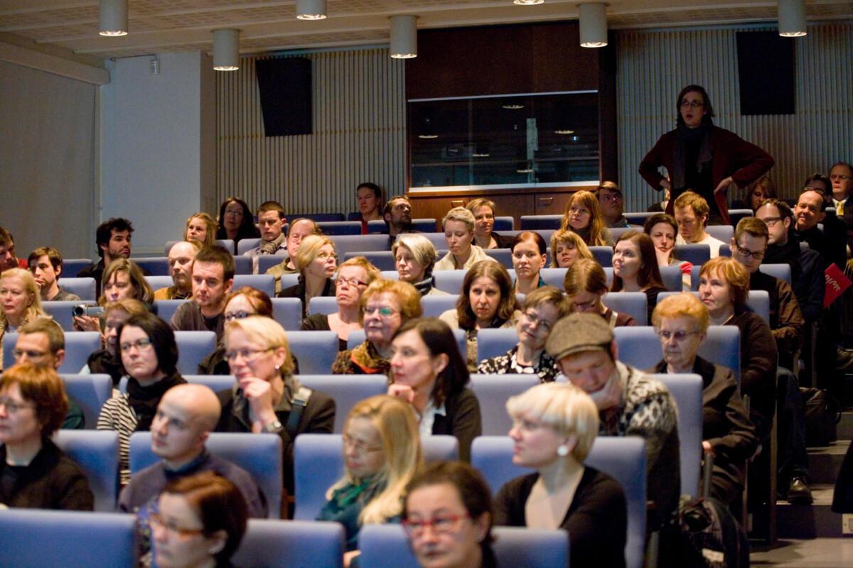 Group of people sitting in an auditorium.