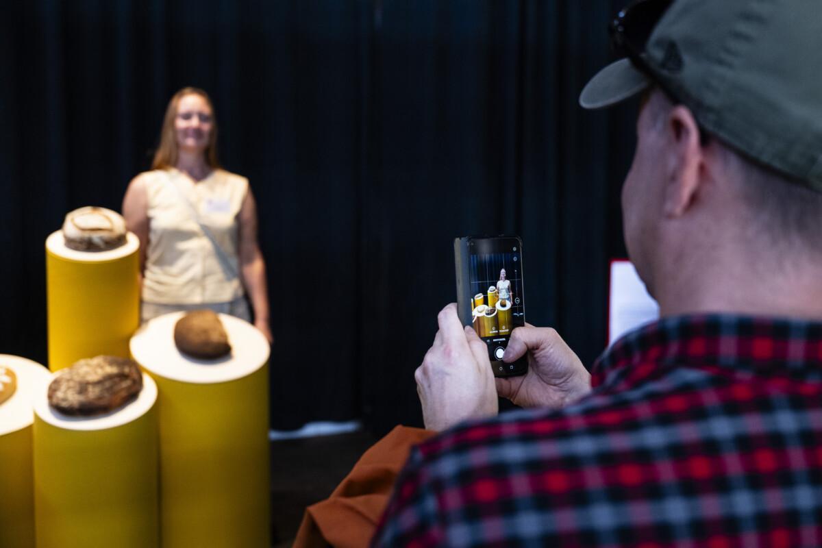 The photo shows one of the finalists photographed with her bread at the bread display.